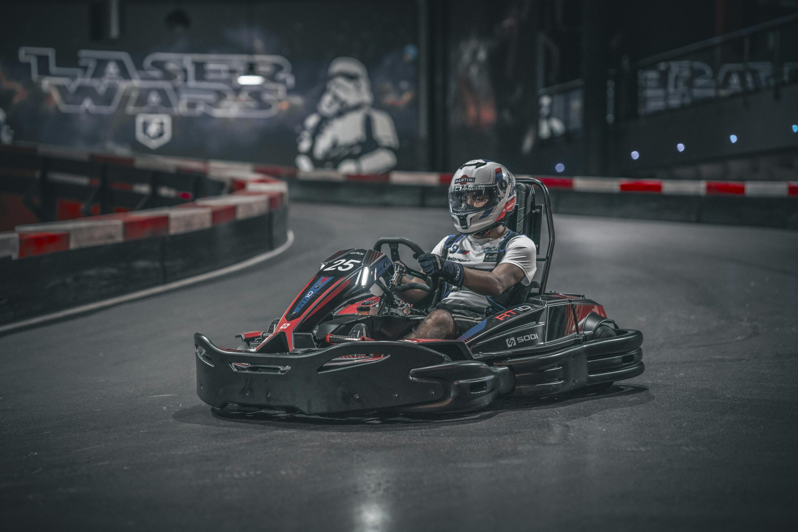 Exciting indoor go-kart racing scene with driver speeding on track.